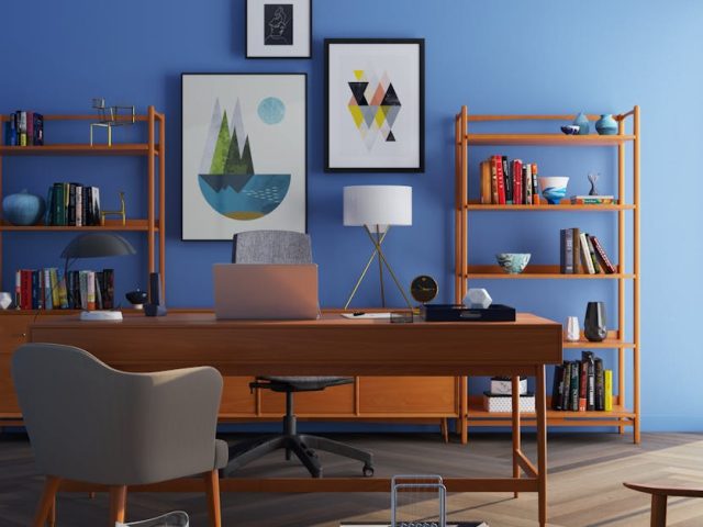 Elegantly decorated home office with modern furniture and a blue wall.